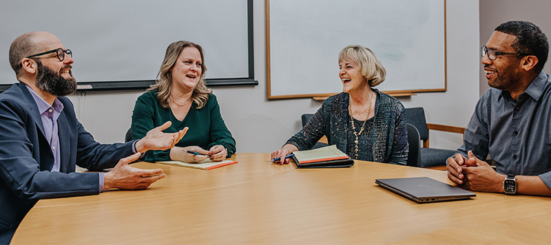 Sue, James, and Dionne at the conference table