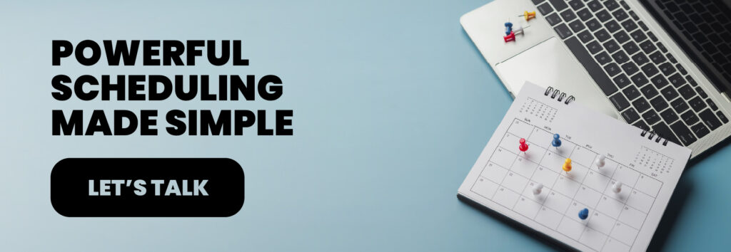 Open laptop with a spiral-bound calendar marked with colorful pushpins, representing simplified employee scheduling and time & labor management through Bennett/Porter&rsquo;s workforce software solutions for Pacific Northwest businesses.